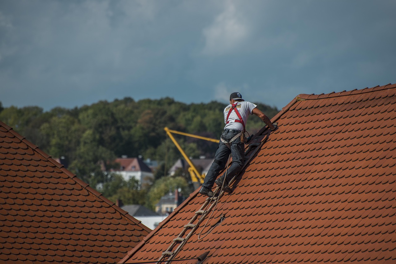 Professional roofing contractor working on residential roof with quality materials